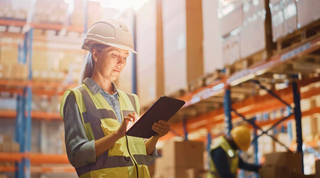 A image show a lady is manage her task via wms panel in warehouse